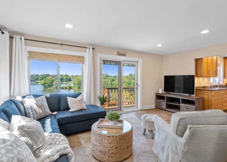 Photo of an AirBnb listing, beautifully staged living room with a lake views
