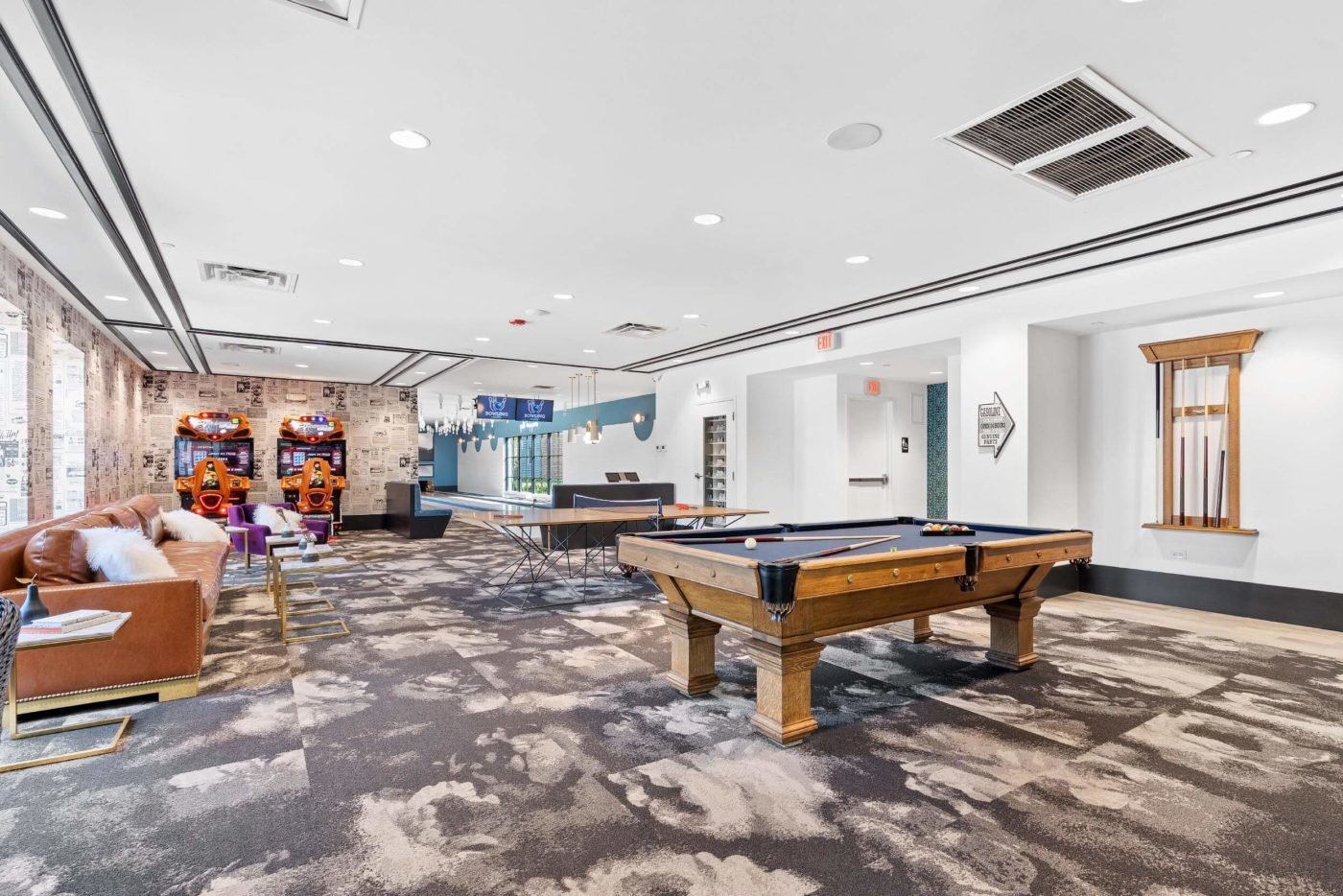Commercial real estate photo of the entertaining area with pool table and bowling lanes